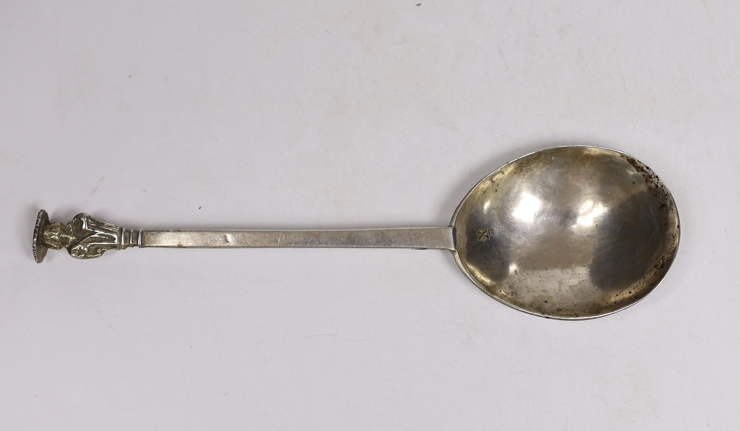An antique white metal apostle spoon, with 'X' stamp to the bowl below a maker's mark?, the bowl back with two sets of prick dot initials, 19.4xm, 46 grams.